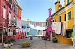 Italy, Veneto, Venice, Burano. Clothes hanging out to dry in the streets