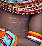 Kenya, Marsabit County, Lasien. A Samburu girl in all her finery. She has neat body scarification as a sign of beauty.