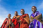 Africa, Kenya, Narok County, Masai Mara. Masai elders dressed in traditional attire at their homestead, preparing for one of their customary ceremonies.