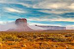 Desert landscape with butte surrounded by low fog, Monument Valley Navajo Tribal Park, Arizona, USA