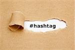 The word Hashtag appearing behind torn brown paper.