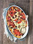 close up of rustic italian baked vegetable ragu with spinach polenta