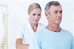 Doctor examining her patient back in medical office