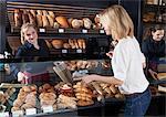 Blonde woman buying organic pastries in a bakery