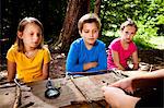 Children crafting in a forest camp, Munich, Bavaria, Germany
