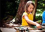Schoolgirl crafting in a forest camp, Munich, Bavaria, Germany