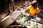 Girl crafting in a forest camp, Munich, Bavaria, Germany