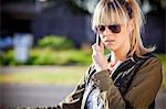 Young woman with sunglasses using mobile phone