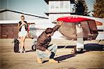 Pilot checking wing of propeller airplane