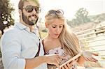 Young couple with digital tablet on sighteeing tour