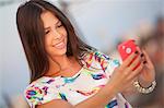 Young woman taking a self portrait with smart phone