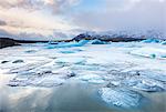 Frozen icebergs locked in the frozen waters of Fjallsarlon Glacier lagoon, South East Iceland, Iceland, Polar Regions