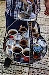 Young man holding a tray with coffee, tea and water in old city, Jerusalem, Israel, Middle East