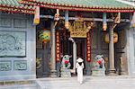 Woman wearing ao dai dress at Nghia An Hoi Quan Pagoda, Cholon, Ho Chi Minh City, Vietnam, Indochina, Southeast Asia, Asia