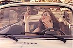 Young Woman Checking her Reflection in Rear View Mirror, Italy