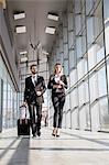 Business partners walking in lobby at airport