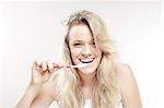 Young woman brushing her teeth