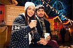 Young couple drinking punch at Christmas Market