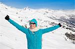 Happy beautiful woman enjoying in snow, Crans-Montana, Swiss Alps, Switzerland