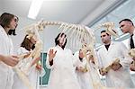 Science students looking at animal skeleton in school classroom