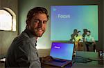 Portrait businessman managing audio visual presentation on Focus