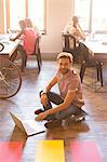 Portrait creative businessman working on laptop on floor