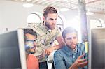 Focused casual businessmen working at computers