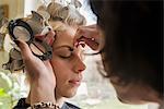 Makeup artist applying make up brush near eye, Munich, Bavaria, Germany