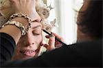 Makeup artist applying eyebrow make up, Munich, Bavaria, Germany