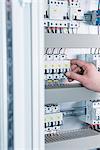 Close-up of electrician switching electrical fuse in distribution fusebox, Munich, Bavaria, Germany