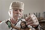 Senior sculptor works on a Jesus Christ statue at workshop, Bavaria, Germany