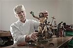 Senior sculptor works on a Jesus Christ statue at workshop, Bavaria, Germany