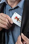 Man putting joker playing card on his pocket, Bavaria, Germany