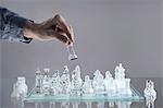 Close-up of man's hand going for checkmate while playing chess, Bavaria, Germany