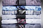 Close-up of stack of dress shirts with ties, studio shot