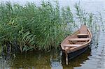 wooden boat over the riverside of lake