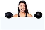 Smiling boxing woman posing from behind a blank whiteboard