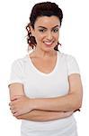 Charming and cheerful young caucasian wearing white t-shirt and posing with her hands crossed