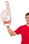 Cropped image of a casual guy with big foam hand. Isolated against white