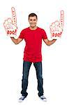 Full length portrait of a young energetic fan showing his spirit by holding two large foam hands