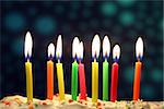 Nine lit birthday candles close up, shallow dof