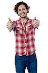 Young man showing double thumbs up