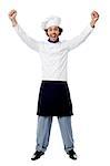 Excited young male chef over white background