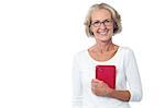 Pretty aged lady holding red color tablet device