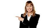 Cheerful businesswoman pointing at something