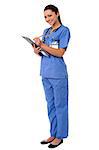 Lady doctor preparing report on clipboard