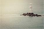 White Lighthouse on the sea and blue sky in Thailand vintage