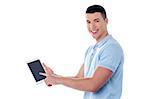 Young smiling man showing his tablet pc device