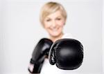 Closeup of woman posing with black boxing gloves
