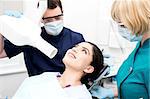 Male dentist takes an x-ray of an woman teeth